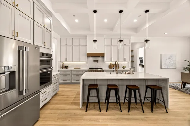 a kitchen with stainless steel appliances a stove a sink and a refrigerator