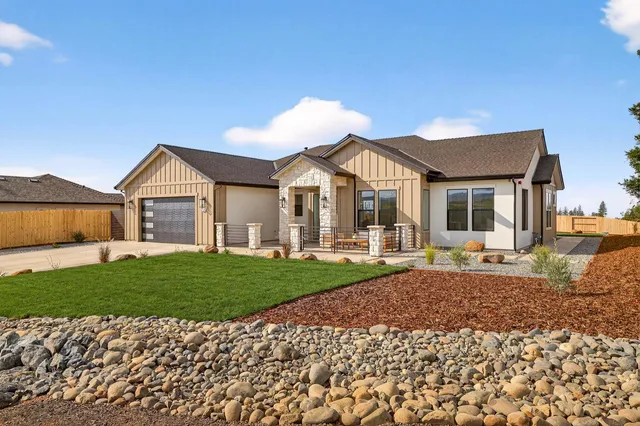a bathroom with a granite countertop sink toilet and mirror