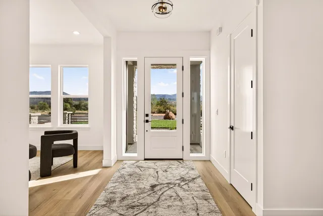 a kitchen with stainless steel appliances a stove a sink refrigerator and a wooden floor