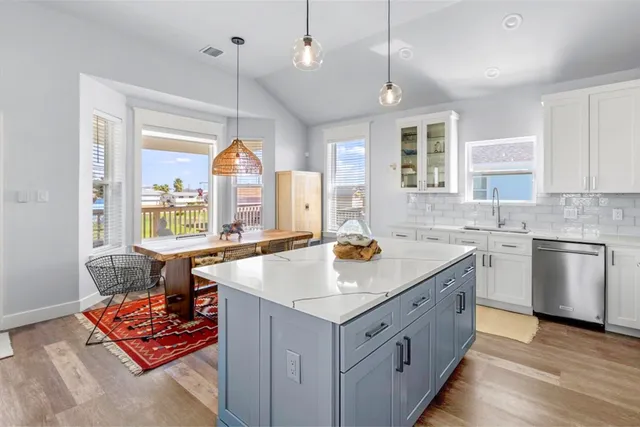 a kitchen with a stove a sink and a refrigerator