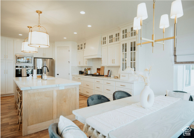 1577 North 1350 E Street, Unit 1 Mapleton, UT 84664 - Photo 3 of 15 Kitchen featuring stainless steel appliances, custom range hood, light wood-style floors, recessed lighting, and a center island with sink