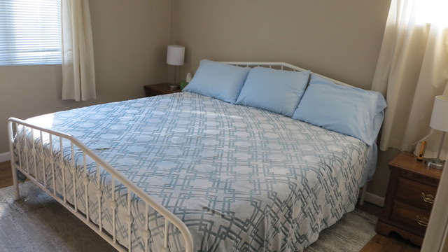 23 Cherry Hill, Unit 124 Hampton, IL 61256 - Photo 13 of 25 a bed sitting in a bedroom next to a window