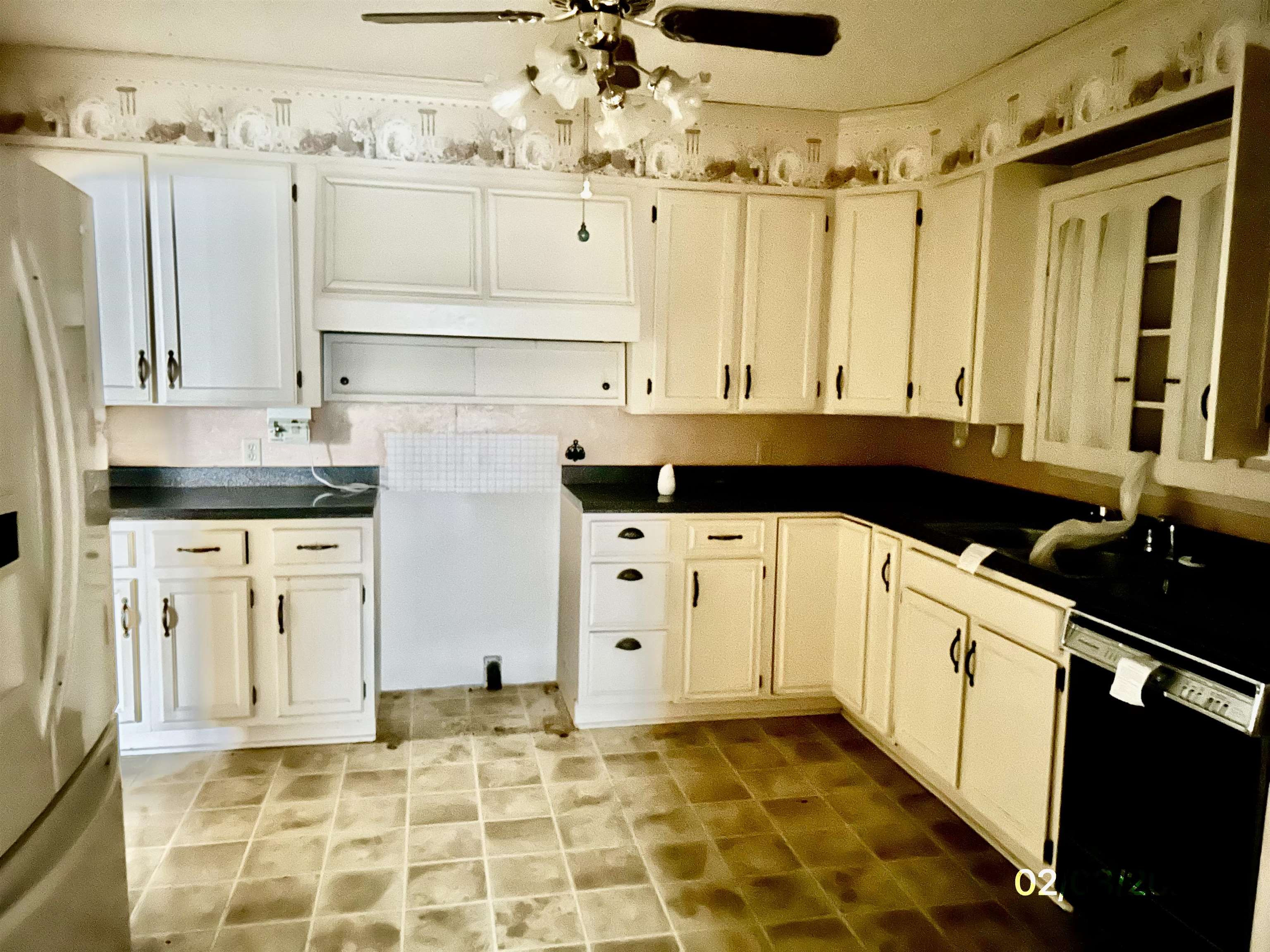 503 Terrace Drive Covington, TN 38019 - Photo 4 of 14 Kitchen featuring white fridge with ice dispenser, black dishwasher, dark countertops, ceiling fan, and white cabinets