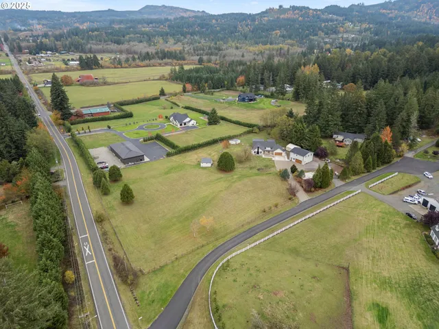 an aerial view of a house with a big yard