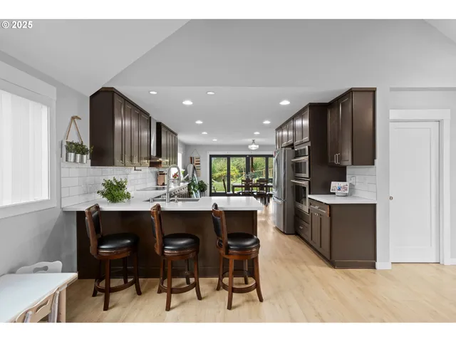 a kitchen with a table and chairs