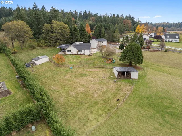 an aerial view of a house with big yard