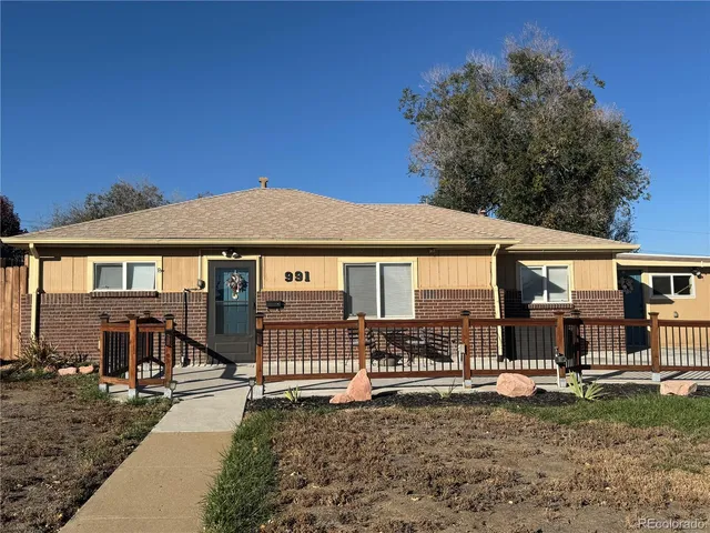 a view of a house with a wooden fence