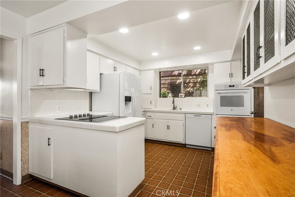 58 Surfside Avenue Surfside, CA 90743 - Photo 12 of 36 a kitchen with stainless steel appliances granite countertop a sink and cabinets