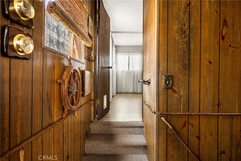 58 Surfside Avenue Surfside, CA 90743 - Photo 15 of 36 a view of a hallway with wooden floor and staircase