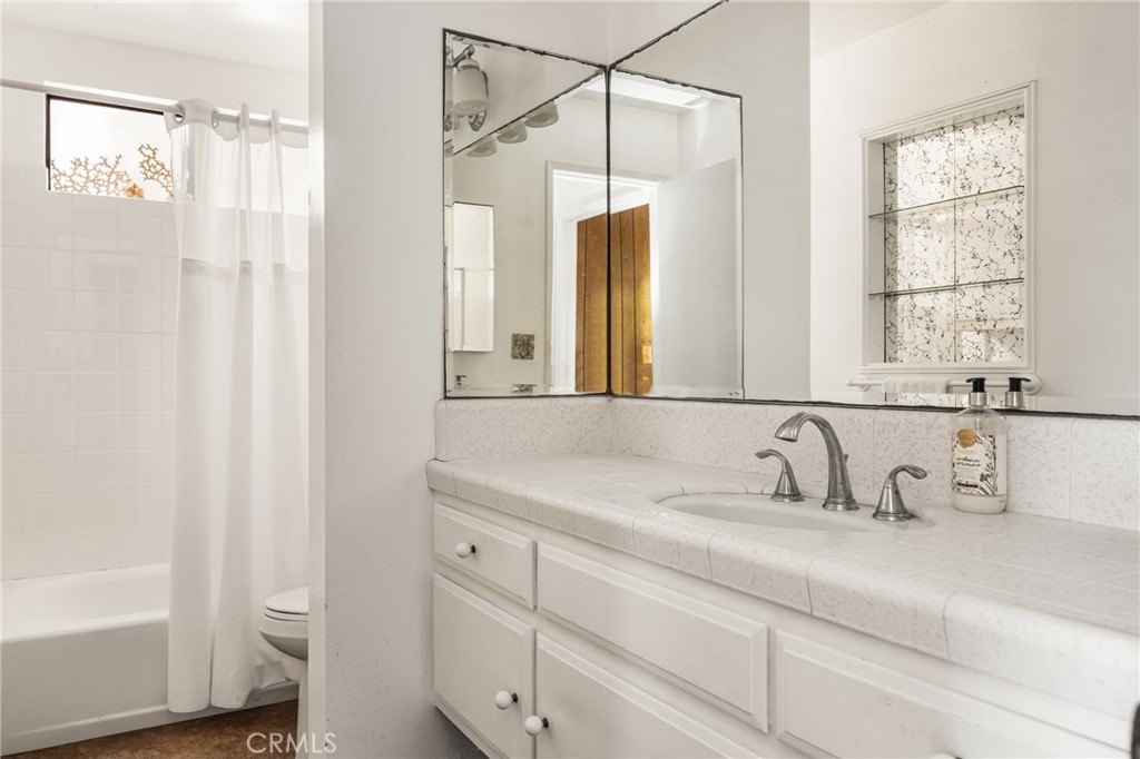 58 Surfside Avenue Surfside, CA 90743 - Photo 20 of 36 a bathroom with a sink and a mirror