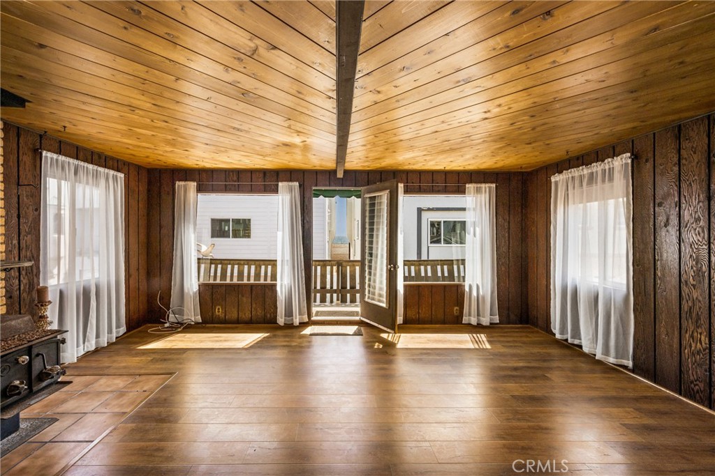 58 Surfside Avenue Surfside, CA 90743 - Photo 2 of 36 an empty room with wooden floor and windows