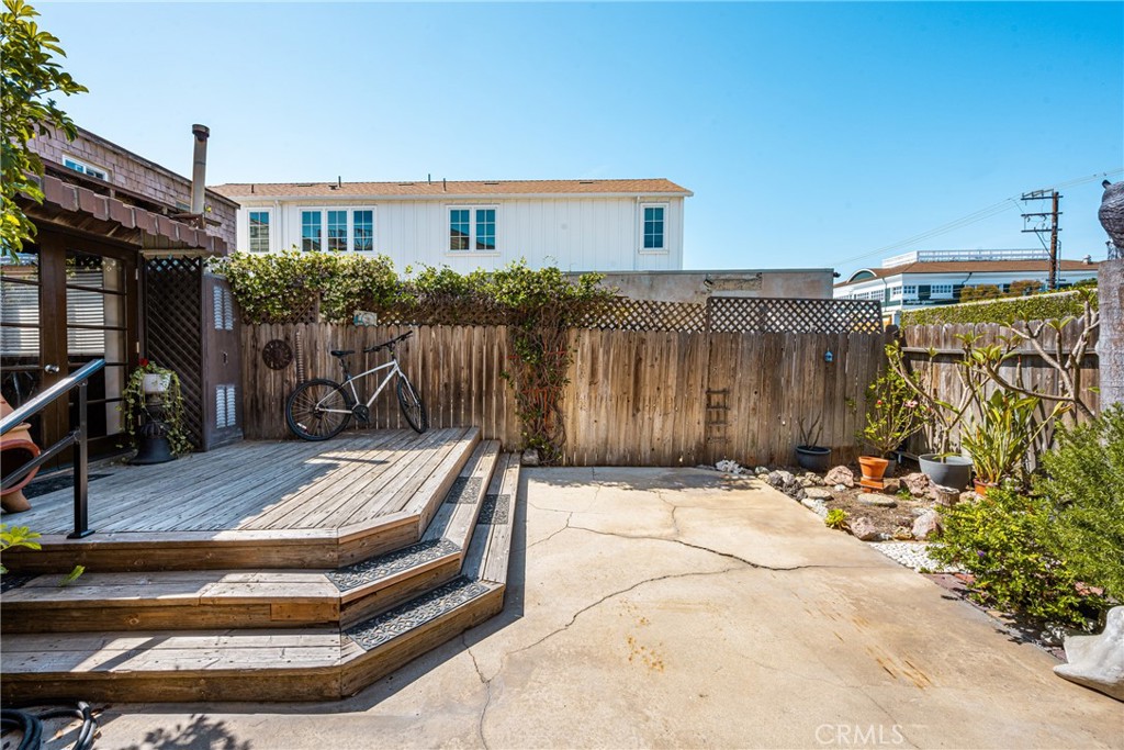 58 Surfside Avenue Surfside, CA 90743 - Photo 22 of 36 a view of backyard with wheel chair potted plants and wooden fence