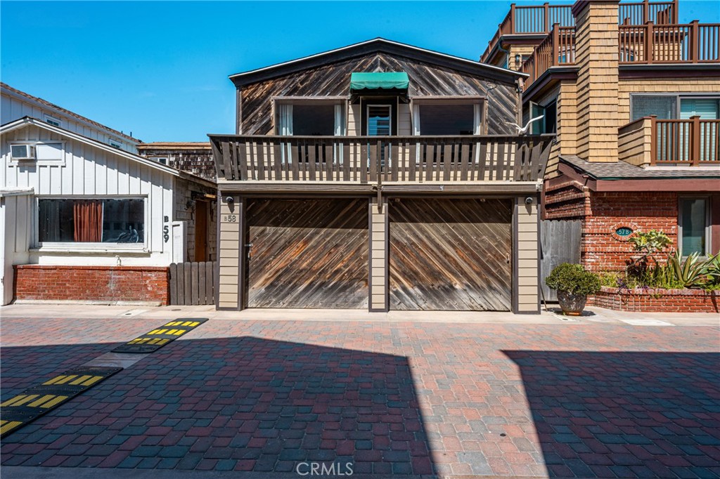 58 Surfside Avenue Surfside, CA 90743 - Photo 3 of 36 a view of front of house with wooden deck