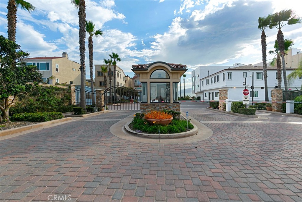 58 Surfside Avenue Surfside, CA 90743 - Photo 33 of 36 a front view of a building with garden and trees