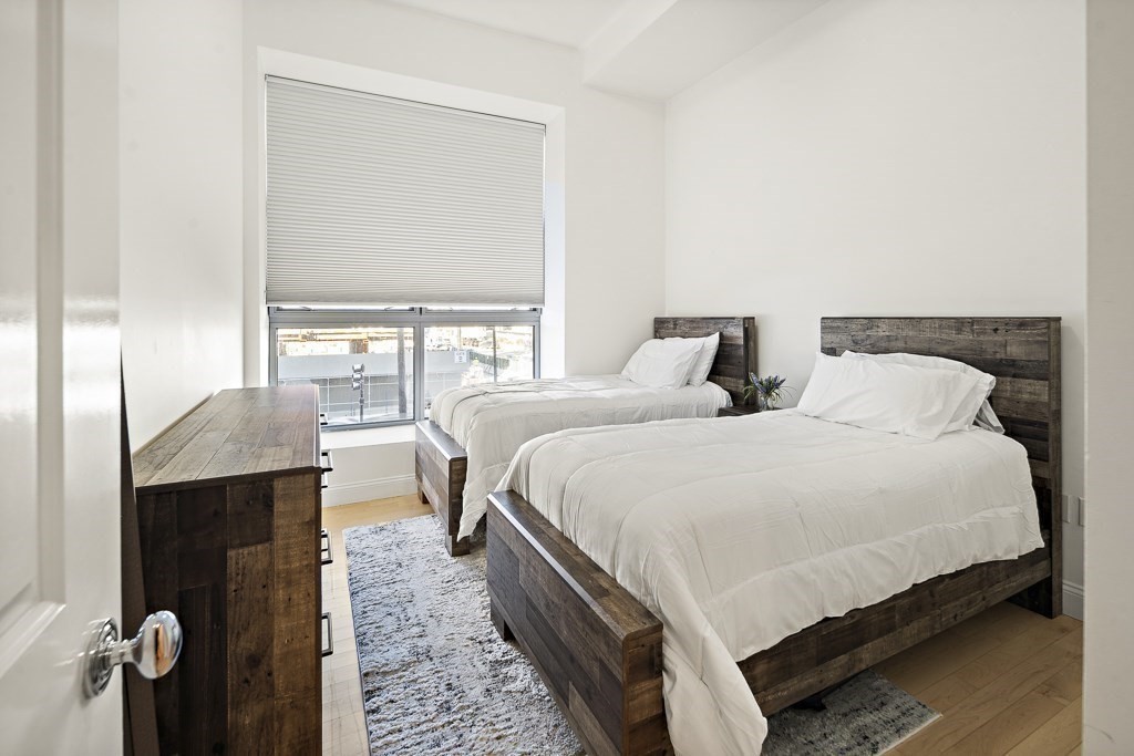 1 Garden Street, Unit FOUR Boston, MA 02114 - Photo 9 of 14 a bedroom with a bed and a table