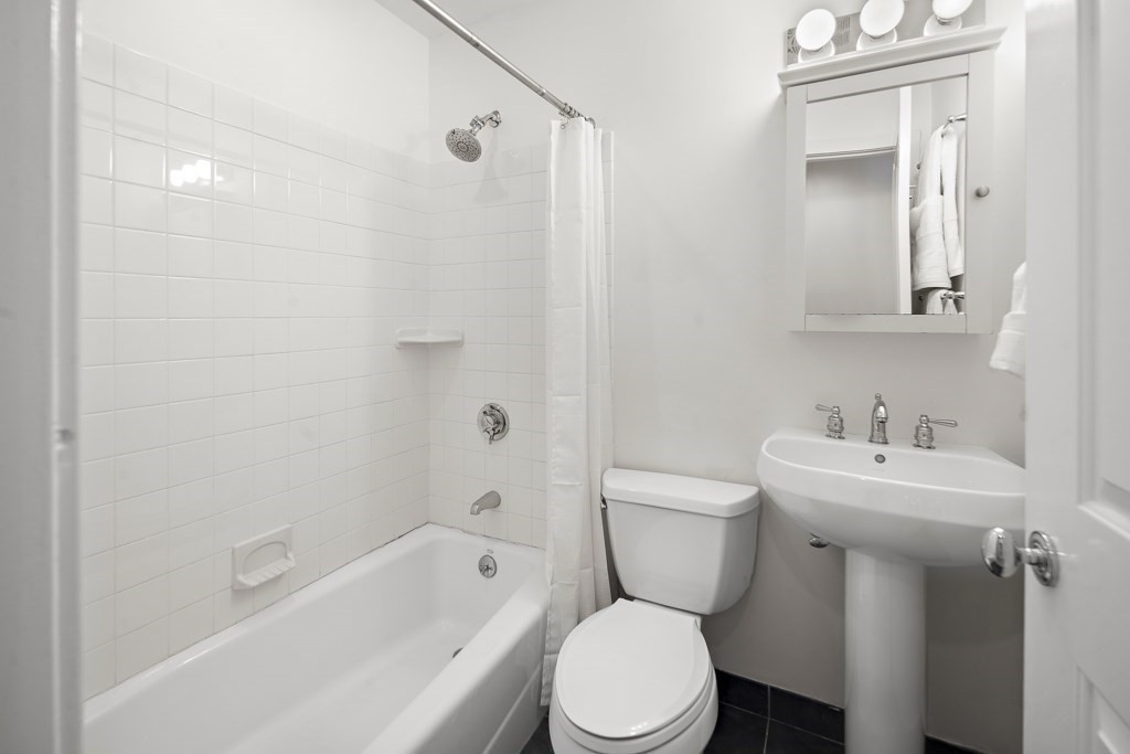 1 Garden Street, Unit FOUR Boston, MA 02114 - Photo 10 of 14 a bathroom with a toilet sink shower and mirror