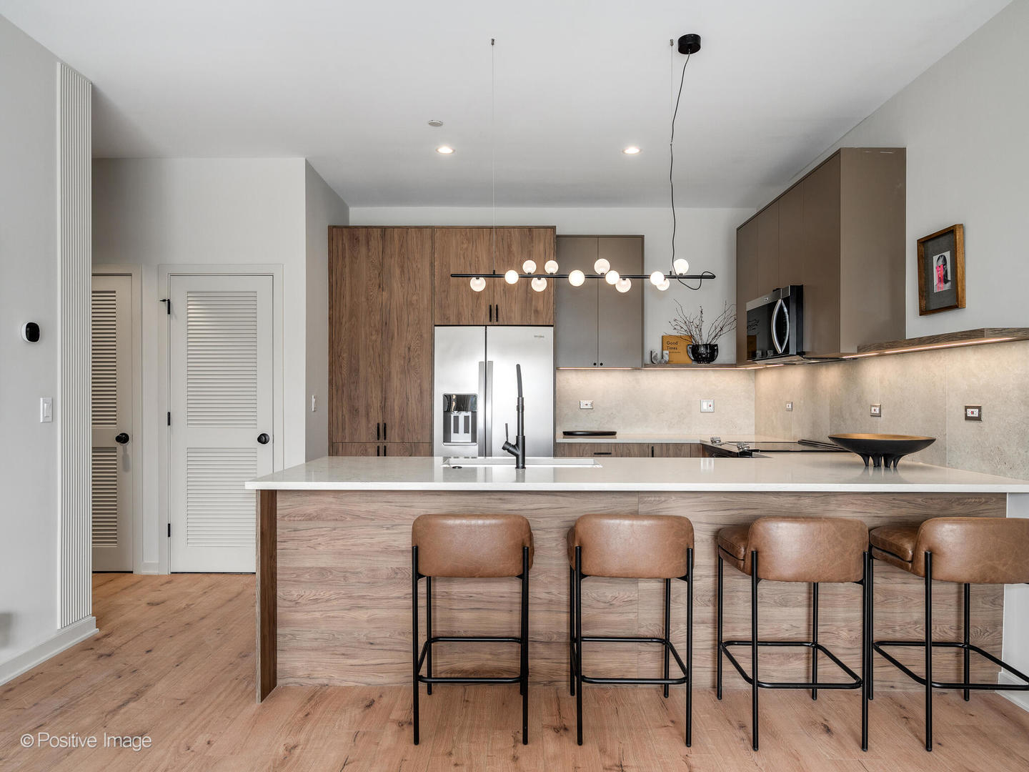 1235 North Ashland Avenue, Unit 302 Chicago, IL 60622 - Photo 20 of 25 a kitchen with kitchen island granite countertop a table chairs sink and cabinets