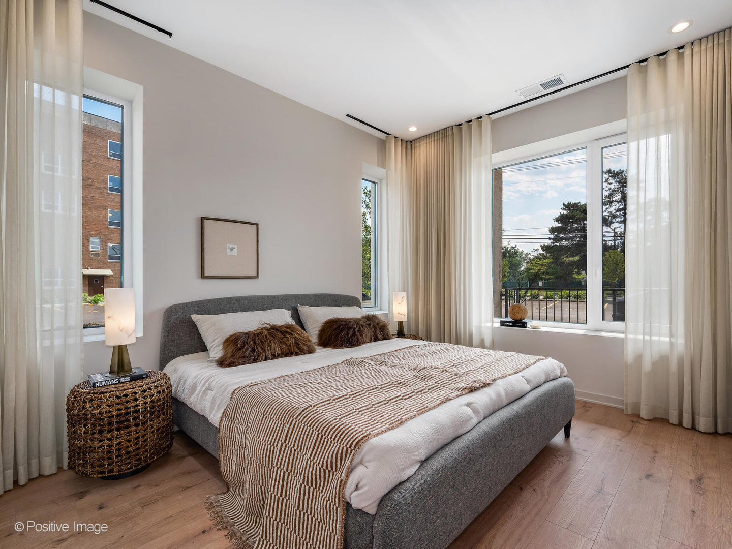 1235 North Ashland Avenue, Unit 302 Chicago, IL 60622 - Photo 21 of 25 a bedroom with a large bed and a window