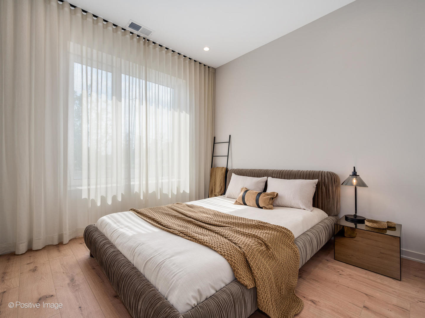 1235 North Ashland Avenue, Unit 302 Chicago, IL 60622 - Photo 24 of 25 a bedroom with a bed and a mirror