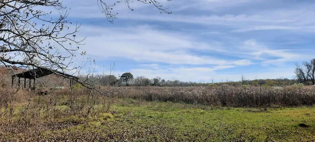 a view of mountain with green field