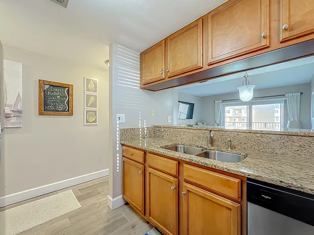 a kitchen with stainless steel appliances granite countertop a sink and cabinets