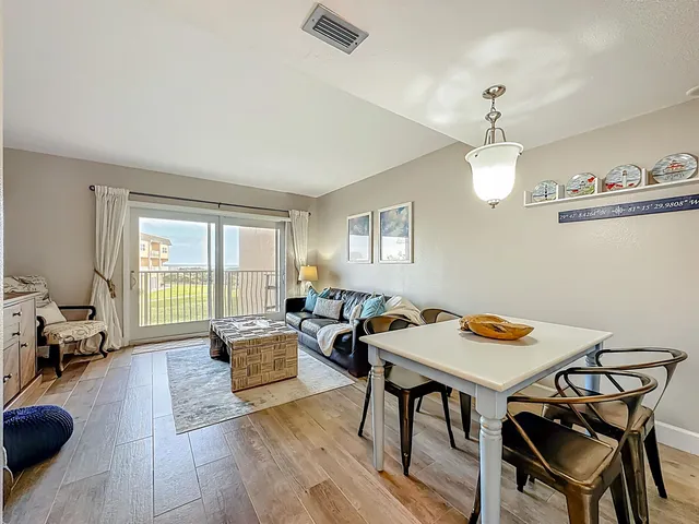 a workspace with furniture a chandelier and wooden floor