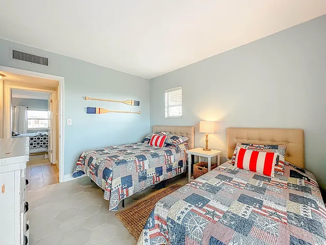 a bedroom with two beds and painted wall