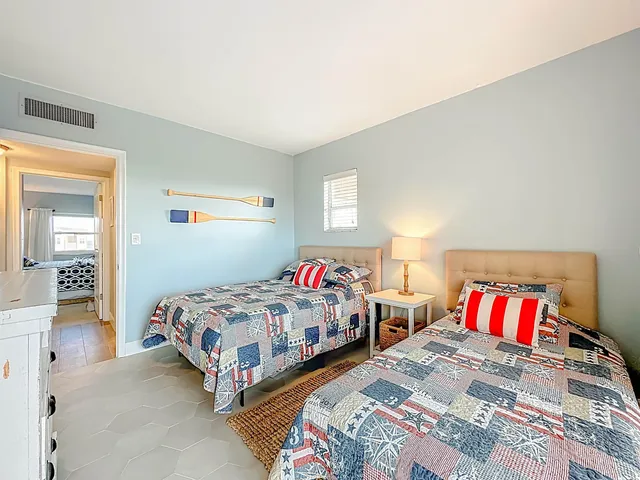 a bedroom with two beds and painted wall