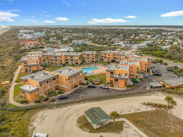 an aerial view of a house with a ocean view