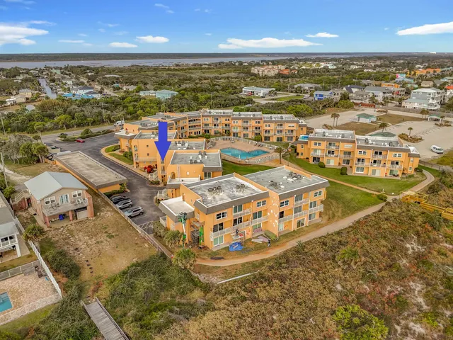 an aerial view of residential houses with outdoor space