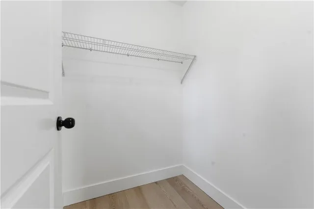 an empty room with chandelier fan