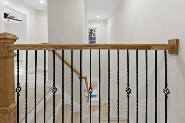 a view of a hallway with closet and bathroom