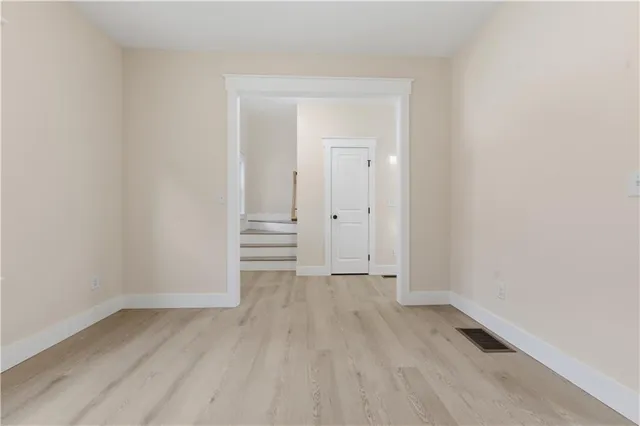 an empty room with wooden floor
