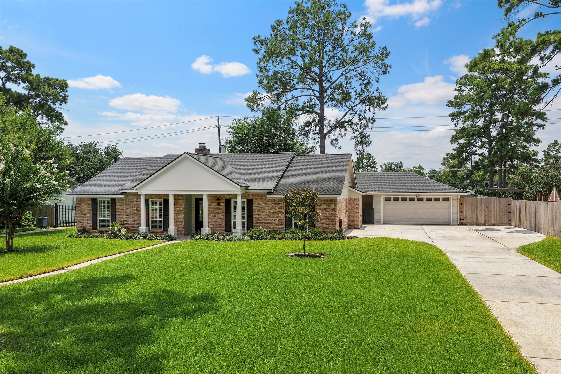 6507 Allentown Drive Spring, TX 77389 - Photo 29 of 30 View of the home featuring a lush yard and a spacious driveway with extra parking.