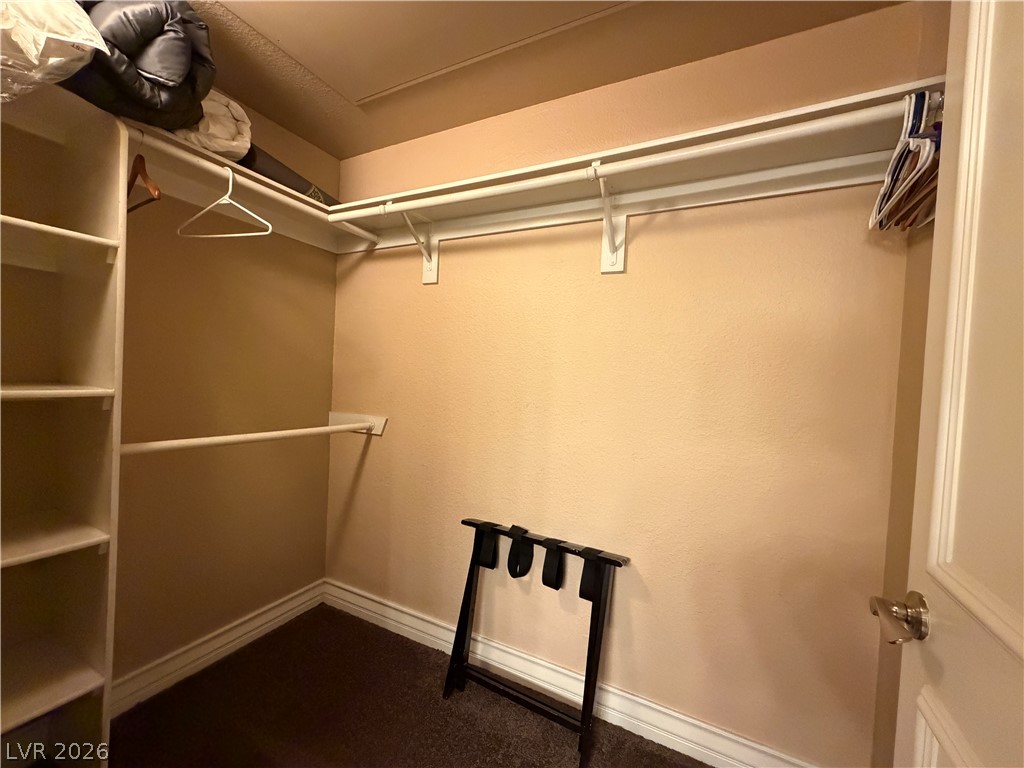 210 East Flamingo Road, Unit 426 Las Vegas, NV 89169 - Photo 13 of 17 Ample storage solutions await in this carpeted closet space, featuring built-in shelving and hanging rods.
