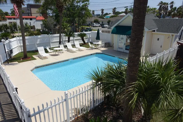 a view of a house with a backyard and trees