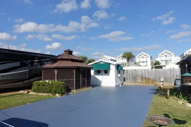 a view of a patio with swimming pool and sitting area