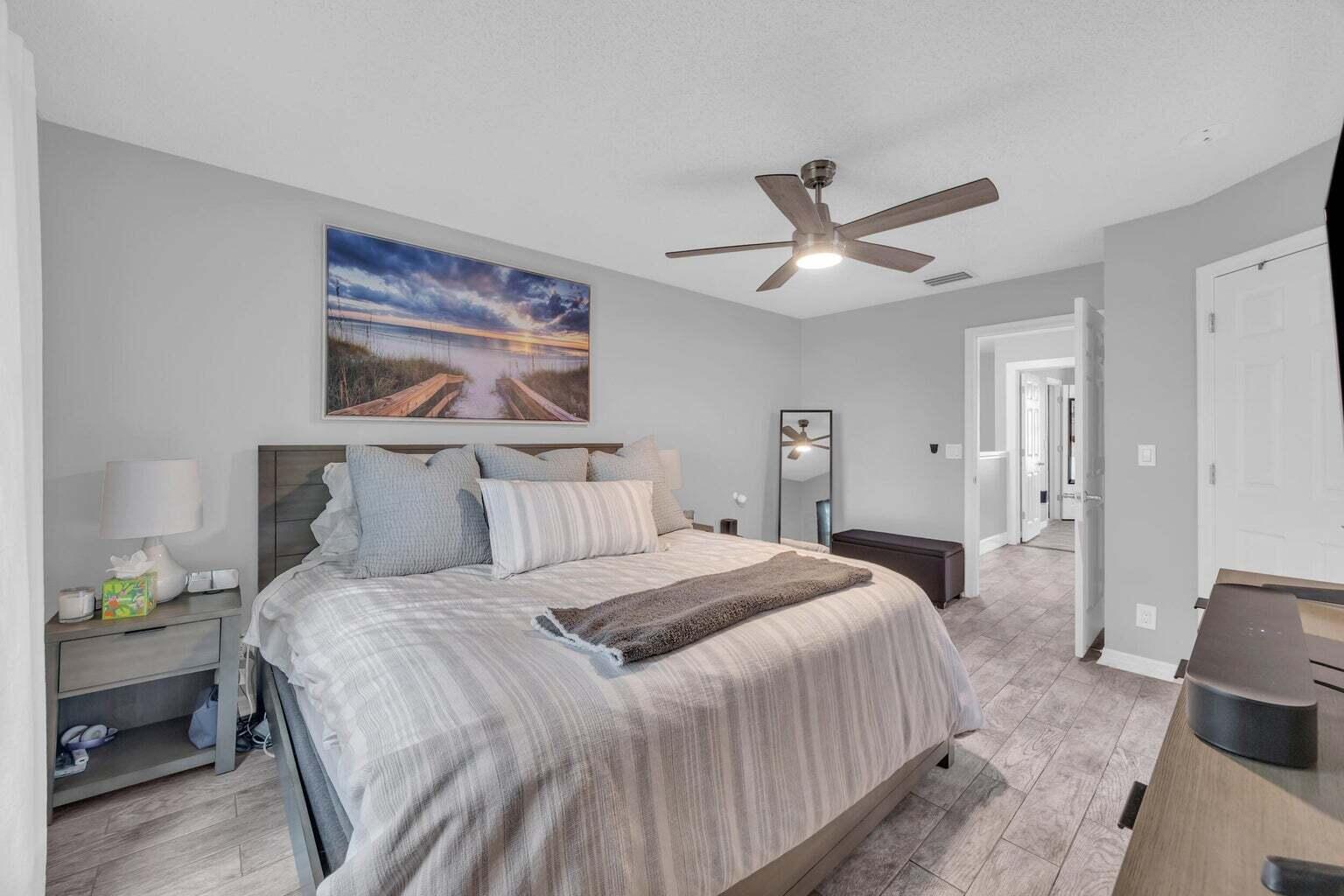 170 Timberwalk Trail Jupiter, FL 33458 - Photo 15 of 28 a bedroom with a bed and painting on the wall