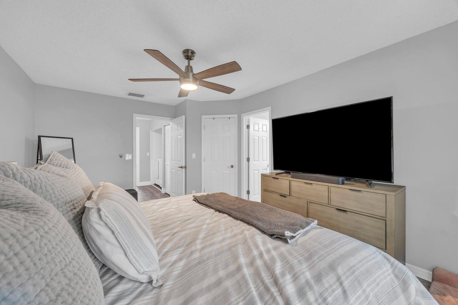 170 Timberwalk Trail Jupiter, FL 33458 - Photo 17 of 28 a bedroom with a bed and a flat screen tv
