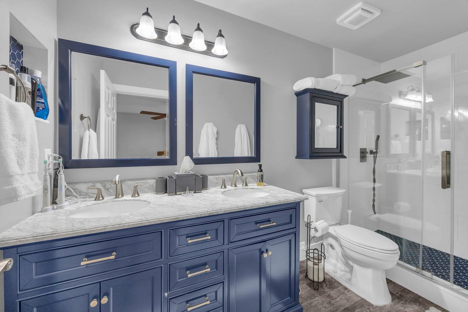 170 Timberwalk Trail Jupiter, FL 33458 - Photo 20 of 28 a bathroom with a toilet a double vanity sink and a mirror