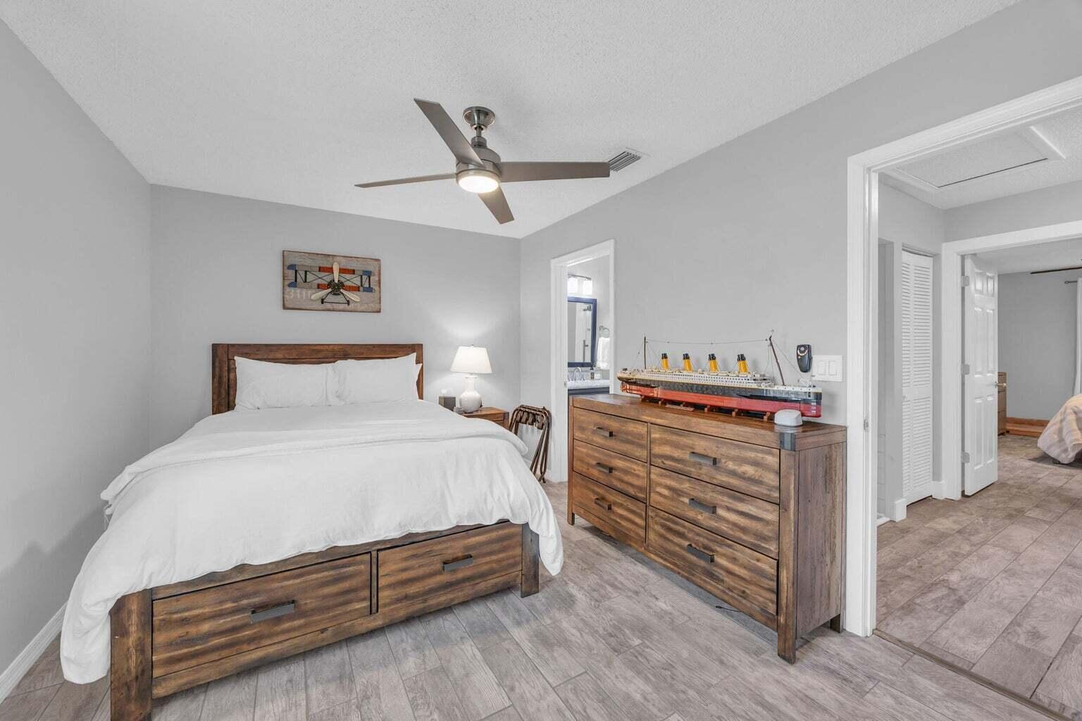170 Timberwalk Trail Jupiter, FL 33458 - Photo 21 of 28 a bedroom with a bed and a ceiling fan
