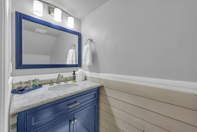 a bathroom with a sink vanity and a mirror