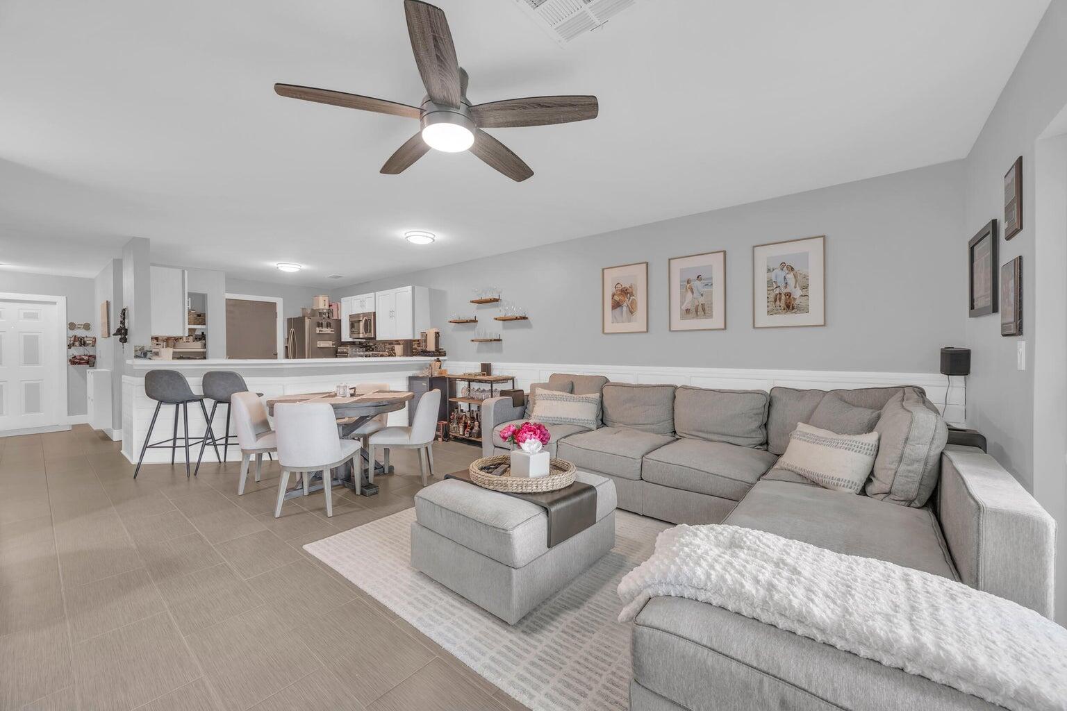 170 Timberwalk Trail Jupiter, FL 33458 - Photo 9 of 28 a living room with furniture kitchen and a chandelier