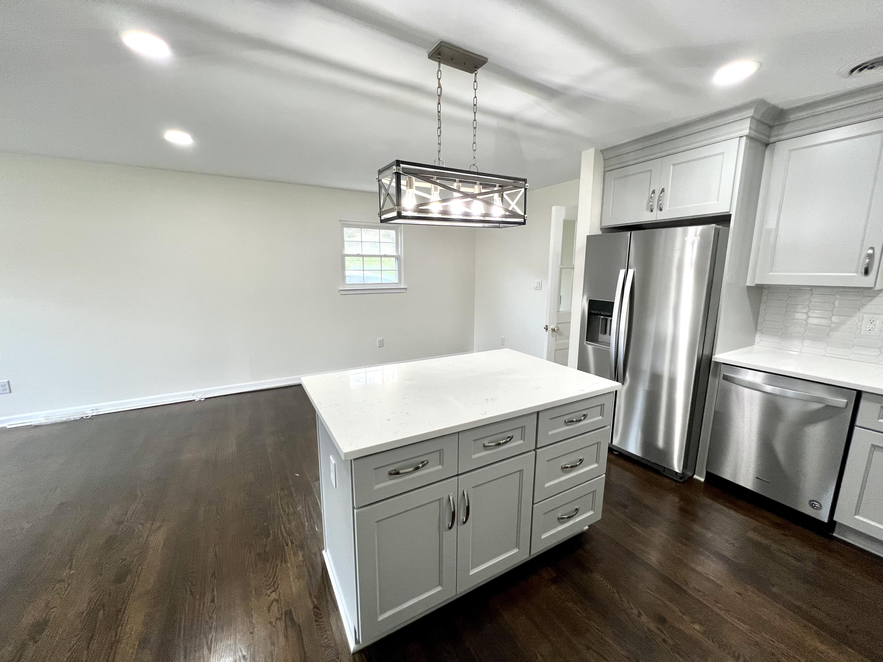 5721 Green Ridge Road Roanoke, VA 24019 - Photo 6 of 16 a kitchen with cabinets wooden floor and stainless steel appliances