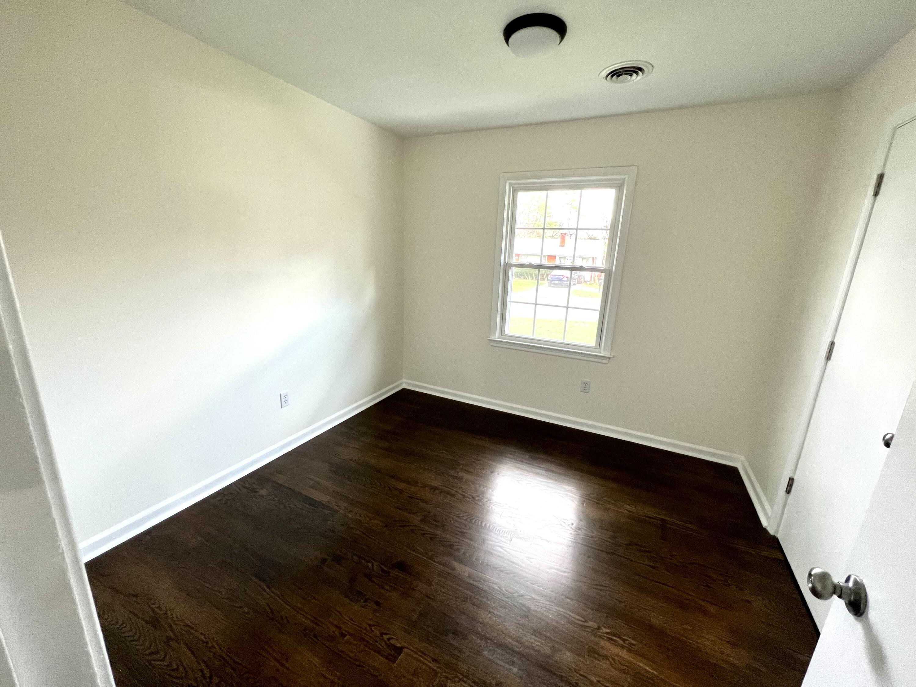 5721 Green Ridge Road Roanoke, VA 24019 - Photo 7 of 16 an empty room with wooden floor and windows