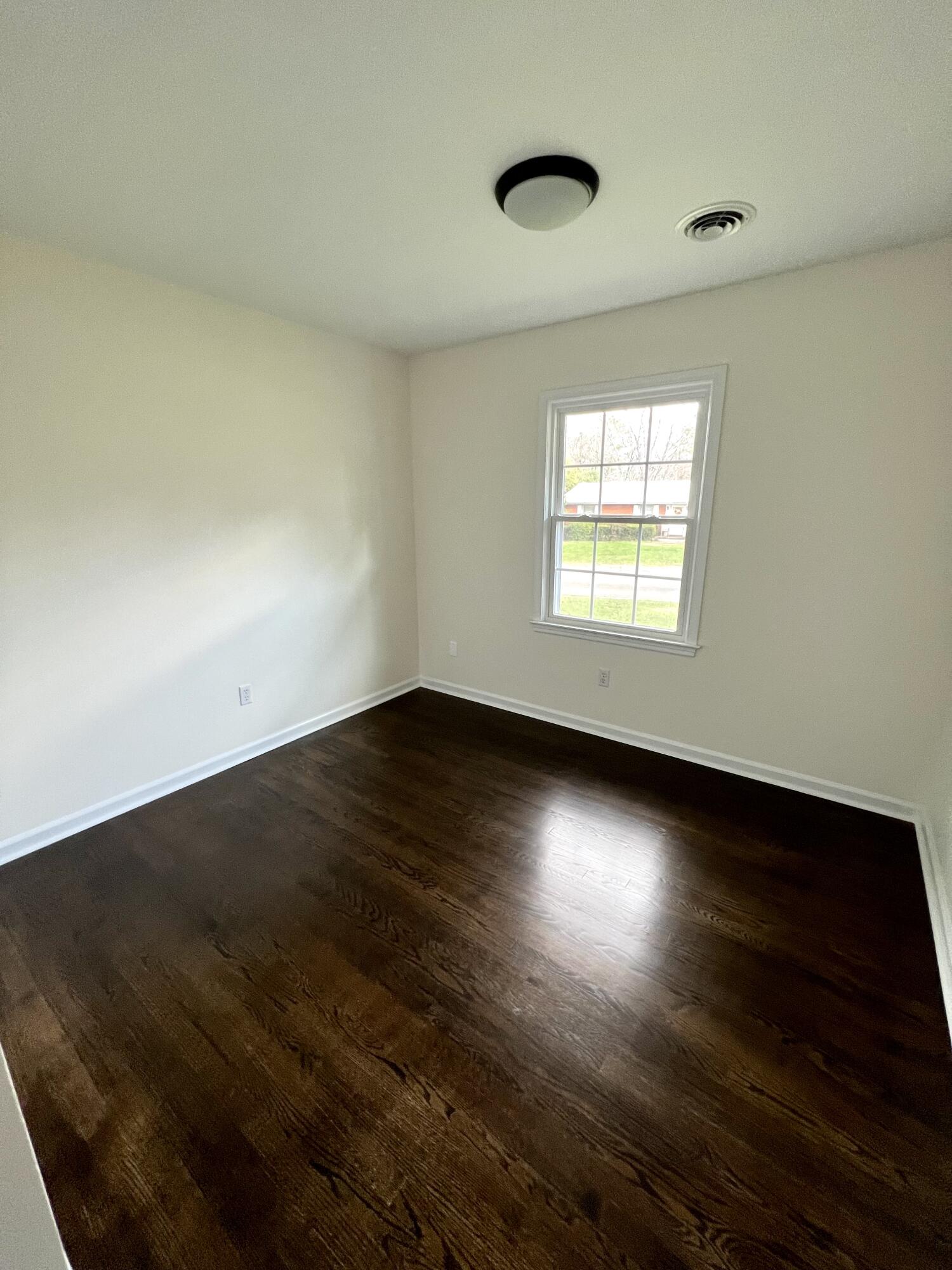 5721 Green Ridge Road Roanoke, VA 24019 - Photo 8 of 16 an empty room with wooden floor and windows