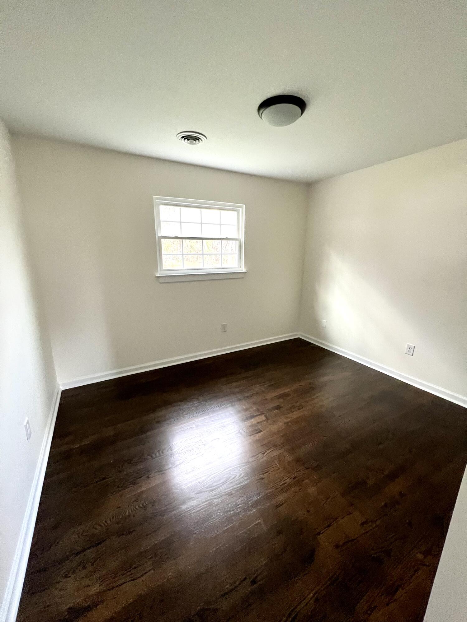 5721 Green Ridge Road Roanoke, VA 24019 - Photo 9 of 16 an empty room with wooden floor and windows