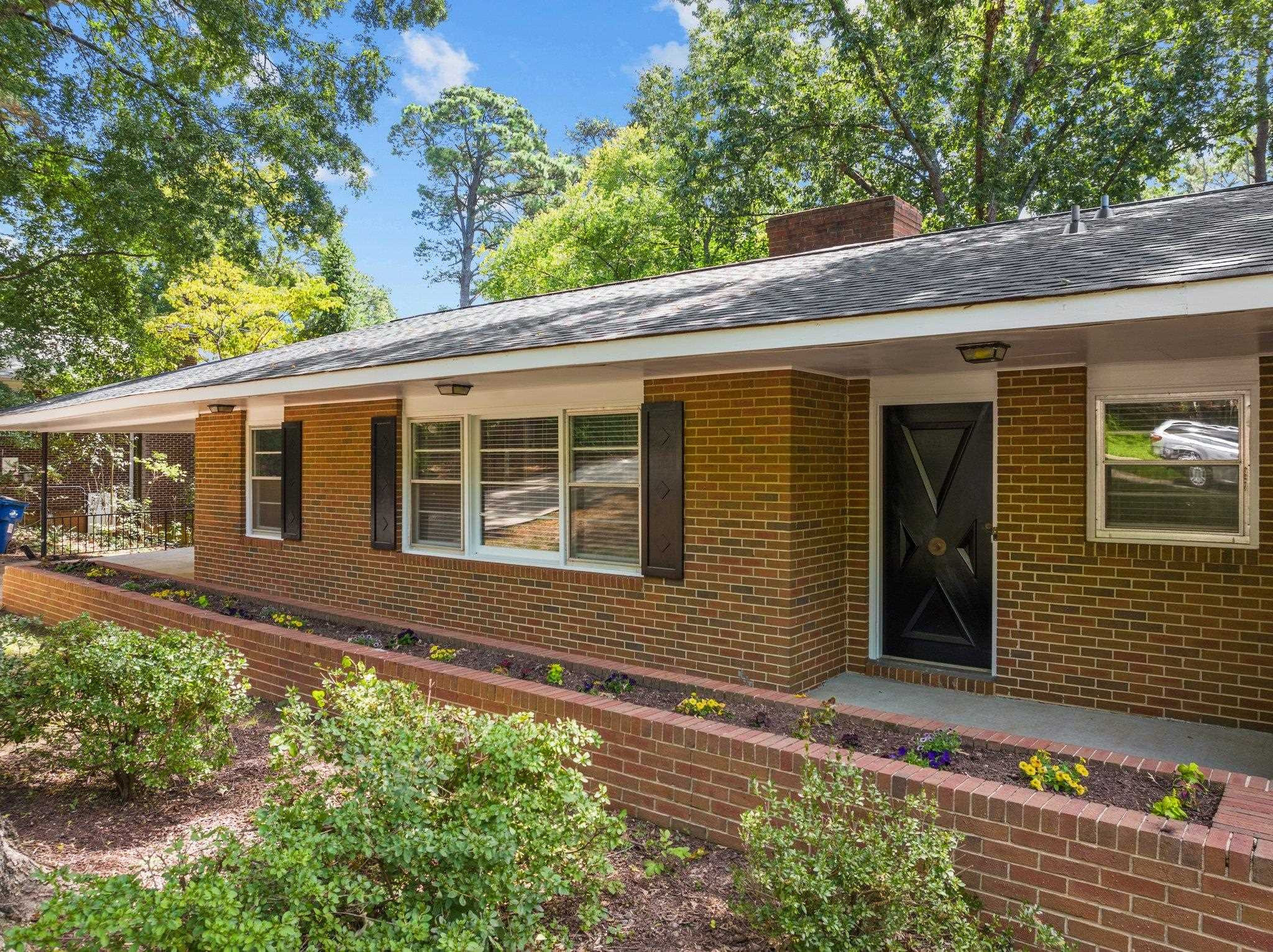 3605 Octavia Street Raleigh, NC 27606 - Photo 17 of 50 a front view of a house with a yard