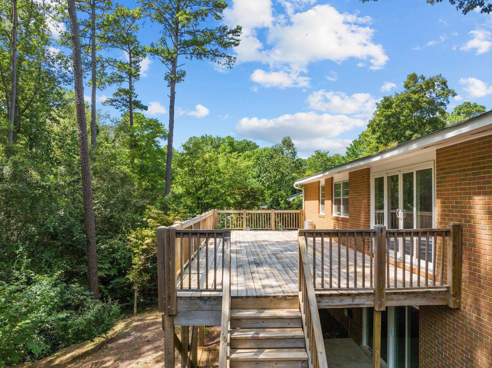 3605 Octavia Street Raleigh, NC 27606 - Photo 30 of 50 a view of a deck with a floor to ceiling window and wooden fence