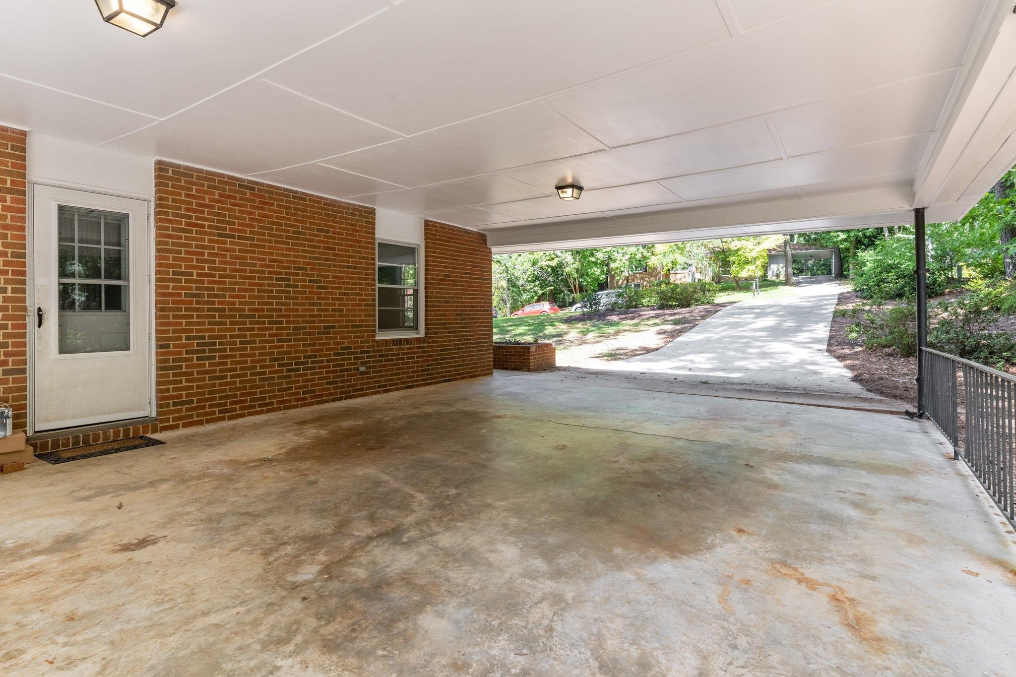 3605 Octavia Street Raleigh, NC 27606 - Photo 34 of 50 a view of a porch with wooden floor and front of a house